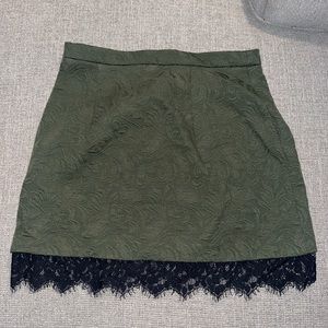 Green mini skirt with black lace detail